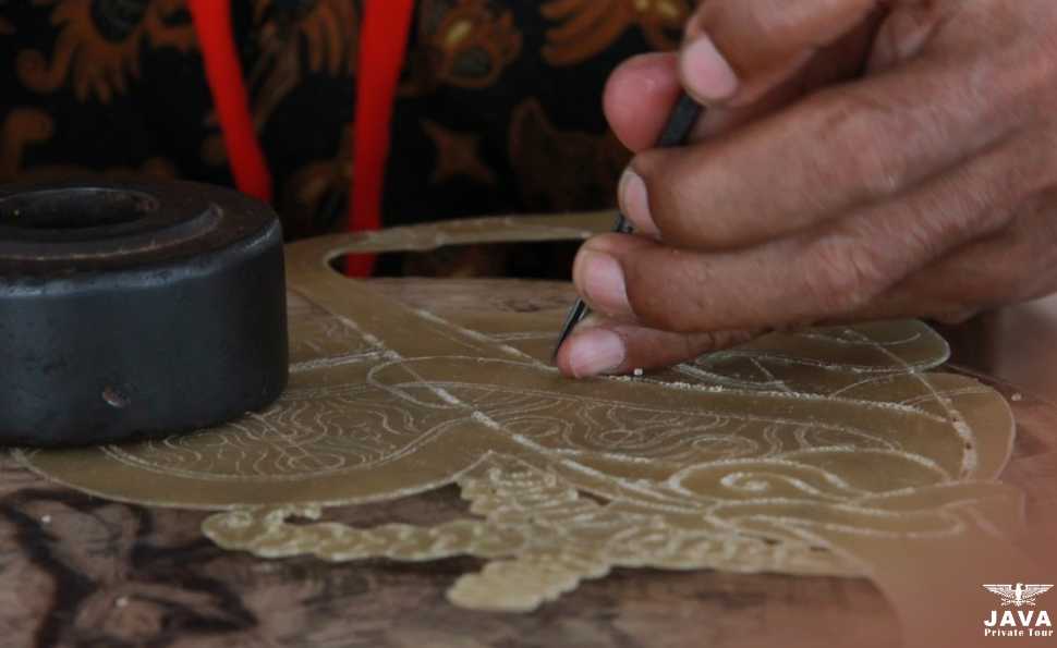 The stage of carving in the process of making wayang kulit is carried out meticulously to achieve a perfect result.